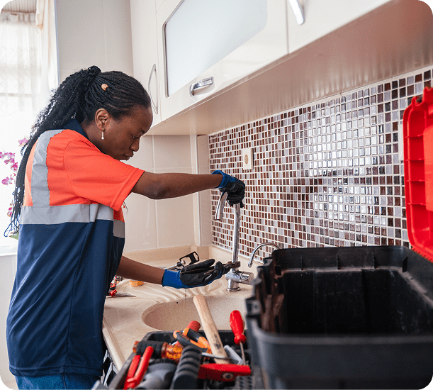 Woman repairing kitchen plumbing