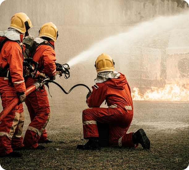 Firefighters extinguishing blaze with hose