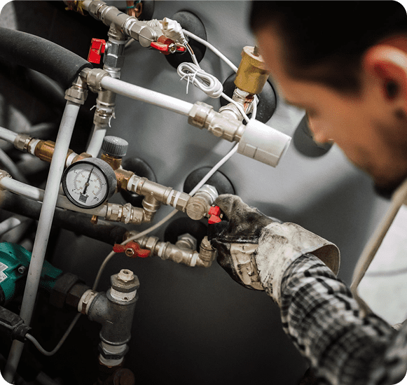 Engineer inspecting pressure gauge and fittings