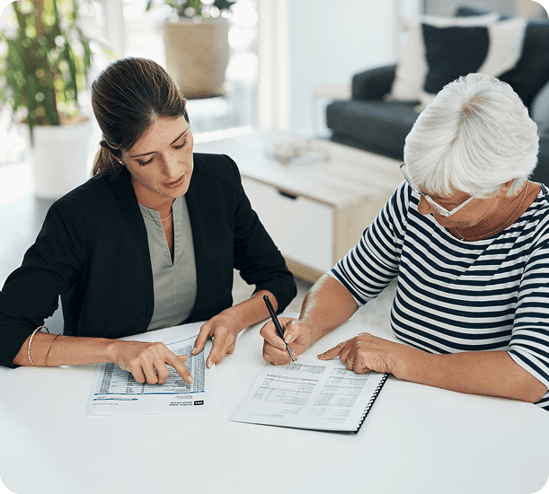 Women collaborating over paperwork in an office.